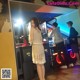 A woman in a white dress playing a video game.