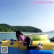 A woman laying on top of an inflatable raft in the water.