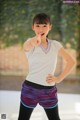 A young girl pointing at the camera with her finger.