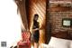 A woman standing in a bedroom next to a bed.