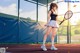 A woman holding a tennis racket on a tennis court.