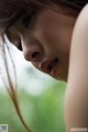 A close up of a woman with long brown hair.